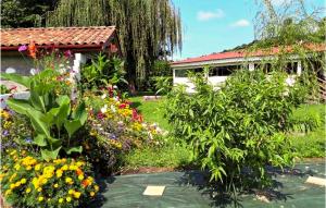 a garden with colorful flowers and a gazebo at Stunning Apartment In Saint-pe-sur-nivelle With House A Panoramic View in Saint-Pée-sur-Nivelle