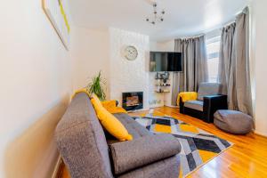 a living room with a couch and a fireplace at Stylish 3-bed Terraced House with Wi-Fi in Chatham