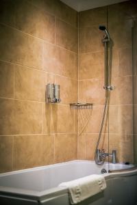 a bathroom with a bath tub with a shower at Three Horseshoes Inn in Durham