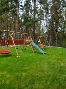 a group of swings in a yard at Dom Przy Lesie na Warmii in Woryty