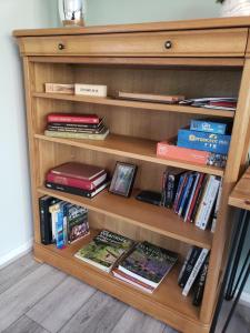 a book shelf filled with books and books at Luxury Self Catering in Colchester in Colchester