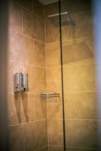 a bathroom with a shower with a glass door at Three Horseshoes Inn in Durham