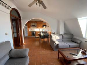 a living room with a couch and a table at CASA Beirada Monte y Playa in Carnota