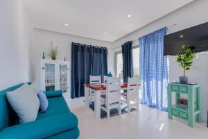 a living room with a blue couch and a table at Luxury Apartment Slavica by the sea,with garden in Sukošan