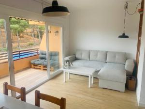 a living room with a couch and a table at Sta Maria Apartment in Tamariu
