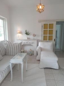 a living room with a couch and a table at Apartment beach house in Chalkida
