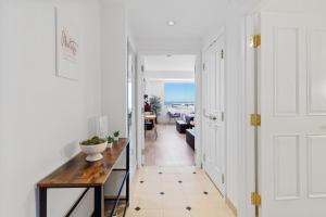 a hallway with a table and a view of a room at Beachfront Double Queen - CozySuites in Atlantic City