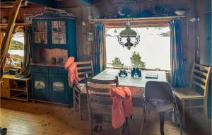a dining room with a table and chairs and a window at 4 Bedroom Nice Home In Etne in Etnesjøen