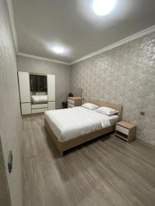 a bedroom with a large bed and a television at Apartment in Monument in Yerevan
