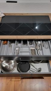 a drawer in a cabinet filled with utensils at Maal Waldhaus in Todtnau