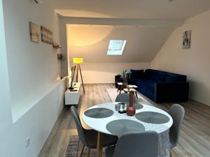 a living room with a table and chairs and a couch at Ilidza Blue Nest in Sarajevo