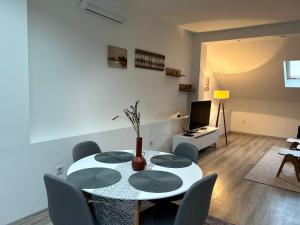 a dining room with a white table and chairs at Ilidza Blue Nest in Sarajevo