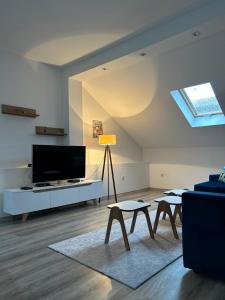 a living room with a flat screen tv and tables at Ilidza Blue Nest in Sarajevo