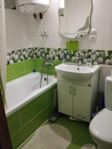 a bathroom with a sink and a tub and a toilet at 2-х комнатная квартира in Odesa