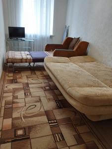 a bedroom with two beds and a rug on the floor at 2-х комнатная квартира in Odesa