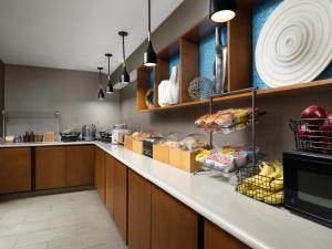 a kitchen with a counter with some food on it at SpringHill Suites Kansas City Overland Park in Overland Park