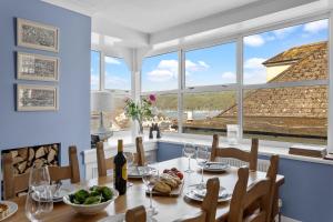 a dining room with a table with food and wine glasses at The Admiralty Wash House in Dartmouth