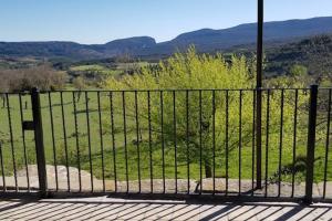 a iron fence with a view of a field at CABAÑA RURAL in Almazorre
