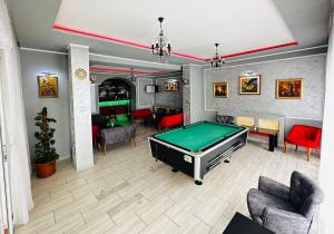 a living room with a pool table in it at Hotel Suprem in Băile Olăneşti