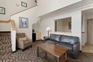 a living room with a couch and a chair at Cedar Street Hotel & Suites in Sandpoint