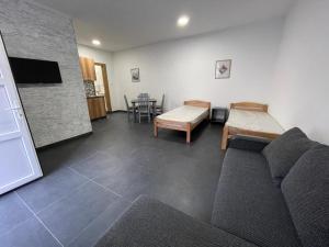 a living room with a couch and a table at Apartmani Milenko in Bela Crkva