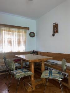 een eetkamer met een houten tafel en stoelen bij Countryside Guest House in Nikšić