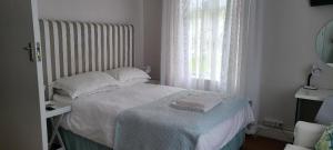 a small bedroom with a bed and a window at Innes Road Durban Accommodation 2 Bedroom Private Unit A in Durban
