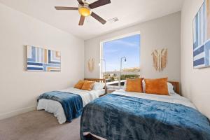 a bedroom with two beds and a ceiling fan at City View - Downtown Walking Palace in Salt Lake City