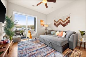 a living room with a couch and a large window at City View - Downtown Walking Palace in Salt Lake City