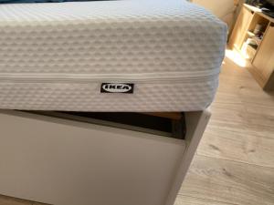 a mattress sitting on top of a white bed at Studio le Monroe les pieds dans l'eau 10 m de la mer in La Seyne-sur-Mer