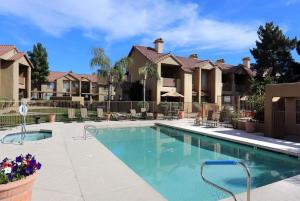 a swimming pool in front of some apartment complexes at NEW CozySuites TPC Scottsdale with parking, pool in Scottsdale