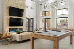 a living room with a pool table and a fireplace at CozySuites Glendale by the stadium with pool 10 in Glendale