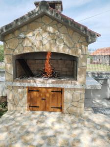 a stone oven with fire coming out of it at Holiday Home Nena in Drniš