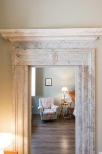a barn door in a living room with a chair at Verità Boutique Apartment in Pietrasanta