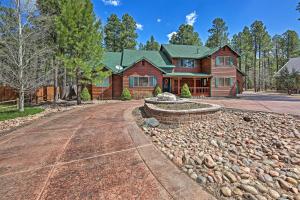 a log home with a gravel driveway at Near Woodland Lake Park Cabin with Serene Deck! in Pinetop-Lakeside