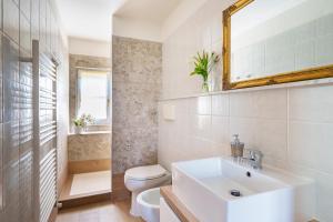 a bathroom with a sink and a toilet and a mirror at Agriturismo San Francesco in Cortona