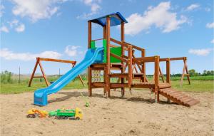 a playground with a slide in the sand at 2 Bedroom Cozy Home In Jaroslawiec in Jarosławiec