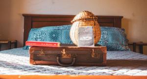 a bed with a book and a basket on top at Chiantissima, Tuscany in Starda