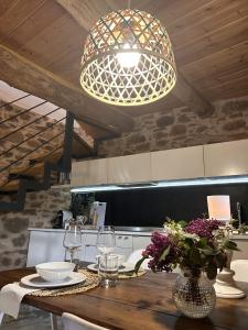 a kitchen with a wooden table with a light fixture at El Secreto De Arlanza in Arlanza