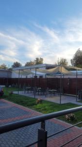 a group of tables and umbrellas in a park at Signature Aparthotel - Boutique in Galaţi