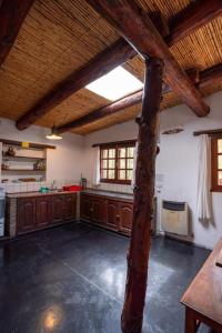 a large kitchen with wooden cabinets and a large window at Cabañas Malka in Tilcara