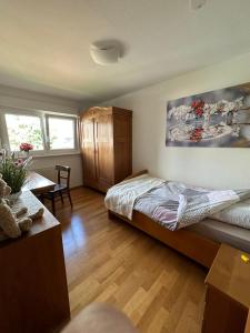 Un dormitorio con una cama y una mesa. en Ferienappartment mit Homeoffice, 2 Schlafzimmer mit Einzelbetten, en Weil am Rhein