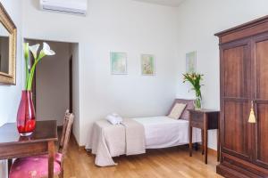 a small room with a bed and a table and a chair at Agriturismo San Francesco in Cortona