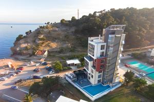 an aerial view of a building next to the ocean at Hotel Porto Sole in Sutomore