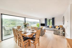 a dining room and living room with a table and chairs at Beach View in Ilfracombe