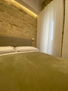 Postel nebo postele na pokoji v ubytování DIMORA DEL CARMINE