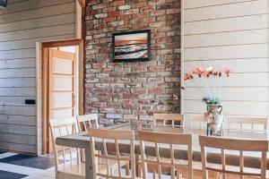 a dining room with a table and chairs and a brick wall at VERTIKĀLES in Liepāja +65 photos