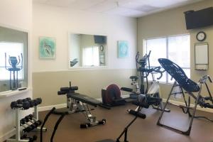 a gym with several exercise equipment in a room at Spa on Port Royal Sound 1321 in Hilton Head Island