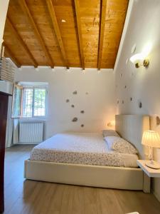 ein Schlafzimmer mit einem Bett und einer Holzdecke in der Unterkunft La Dimora Degli Olivi Dependance in Galbiate