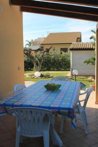 a blue table and chairs on a patio at Ville Tiffany in Campofelice di Roccella